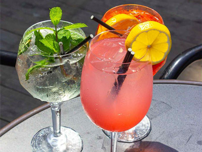 An orange coloured cocktail sitting on a table