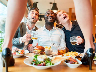 Three boys looking up at a woman at a steak and strip dinner