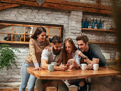 A group of people playing Save The Groom on their phones