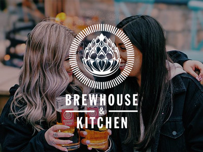 Two girls with a pint in hand with the Brewhouse and Kitchen logo overlayed