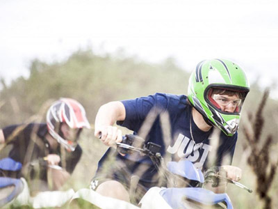 Someone on a quad bike racing another person on a quad bike with Max Events