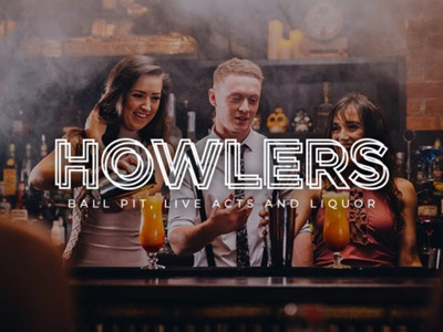 Three bartenders making cocktails at the bar at Howlers in Newcastle