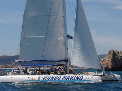 A large catamaran on the sea available to hire out with Ultimate Stag Extreme Hen CB