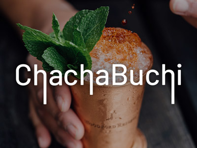 An orange cocktail with lots of ice and a sprig of mint in a copper cup at ChachaBuchi in Newcastle