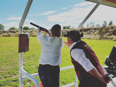 A woman aiming a gun toward the sky at Clay Pigeon Shooting in Dublin