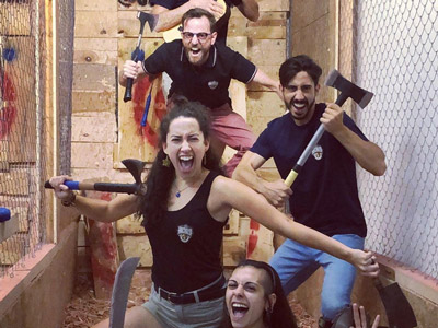 An axe that has been thrown and has hit the bullseye on a wooden block at Axe Throwing by Stag Hen Spain in Valencia
