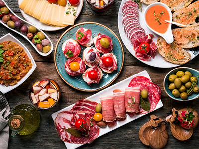 A selection of tapas food on a wooden table in Valencia