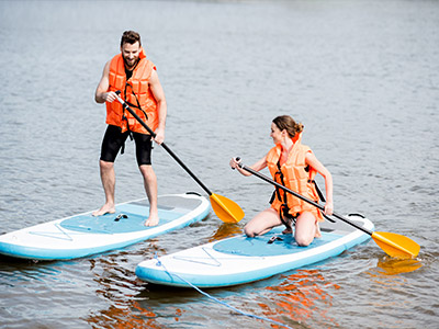 Two people learning how to paddle board on a cloudy day with Stag Hen Spain in Valencia