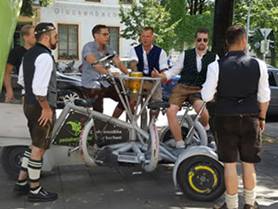 A group of men on a prosecco conference bike in Munich