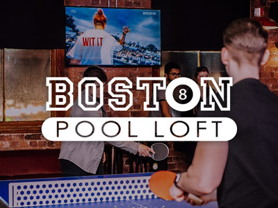 A couple of people playing ping bong with a TV in the background at Boston Pool Loft in Liverpool