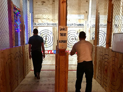 Two men at axe throwing with Mad Max Adventures in Edinburgh