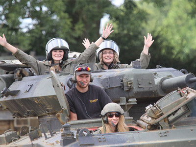 Four people in a tank testing out driving at Armourgeddon