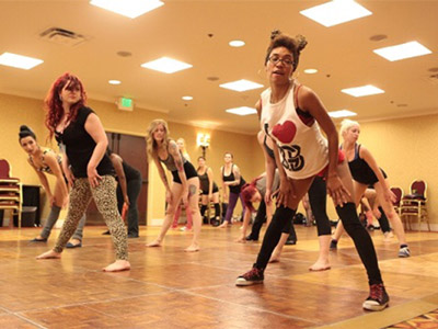 A group of woman learning how to twerk at a twerking dance class