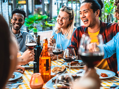 A group of people enjoying cocktails, wine and a BBQ
