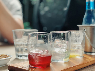 Three glasses of different gins lined up on a wooden board at a Gin Tasting Experience in Dublin