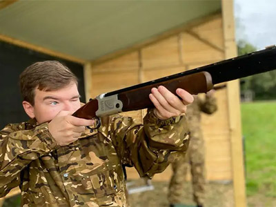 A man aiming a gun at a target at Laser Clay Pigeon Shooting in Birmingham