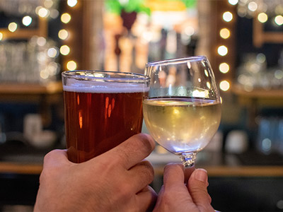 Two people clinking their glasses on a bar crawl in LisbonTwo people clinking their glasses on a bar crawl in Lisbon