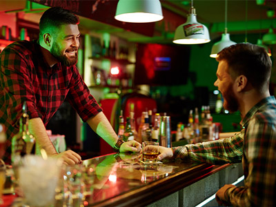 A bartender serving someone on a bar crawl in Madrid