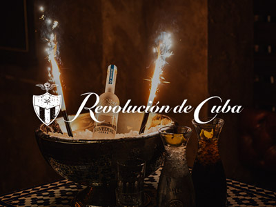 A bucket with alcohol and ice in with the Revolucion de Cuba logo overlayed