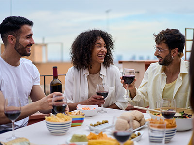 Two people with glasses of wine having a meal in Lisbon