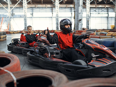 Two people in go karts about to race indoors in Bucharest