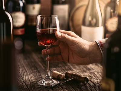  Someone holding a glass of wine to try at a wine tasting experience in Lisbon