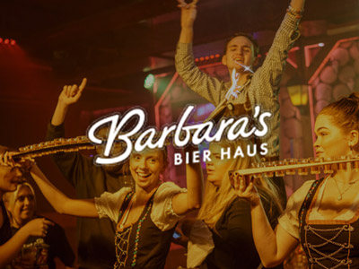 People carrying out trays of shots with a sparkler coming out of the top at Barbara's Bier Haus