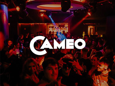 A group of people dancing under red lighting at Cameo in Bournemouth