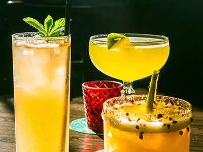 Three different yellow coloured cocktails 