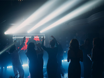 People dancing in front of a DJ at a club in Lisbon