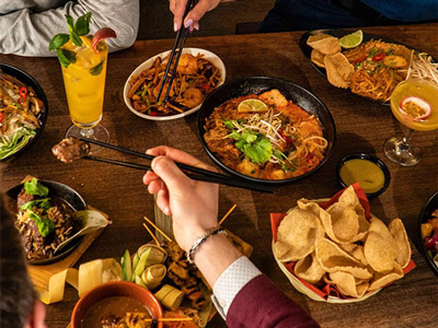 A table laid out with various dishes of food at Banana Tree in London