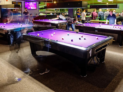 Various purple pool tables in a room at The Ball Room in Glasgow