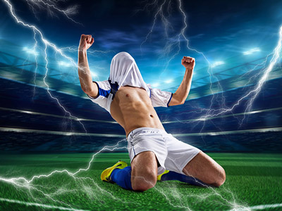 Someone sliding on a football pitch with their top over their face and fake lighting around him at electric shock football