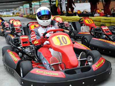 Someone dressed in karting clothing sat on a kart in Prague