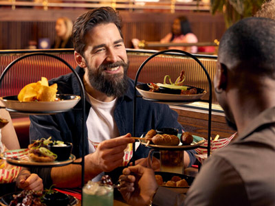 Men sat eating from tiered plates at Friday's 