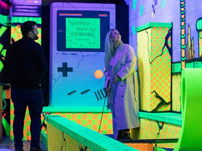 A group of people enjoying food and drinks at Big Fang Crazy Golf