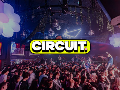 People on a dance floor with cool lights above it at Circuit