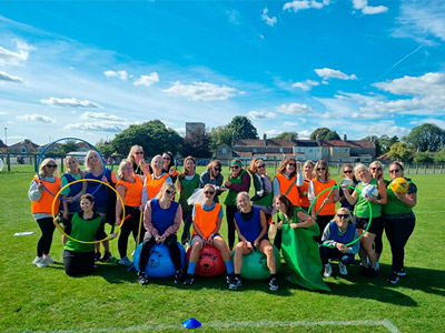 A group of people dressed in old school sports day vests