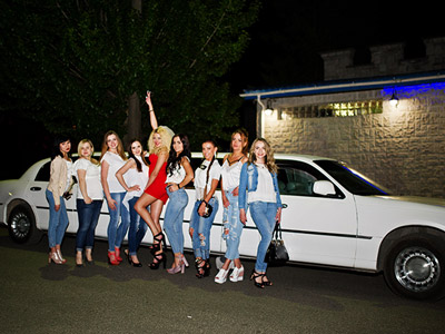 A group of girls stood outside of a airport limo transfer in Lisbon
