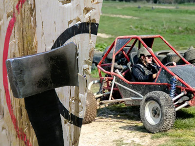 Split image with the left side being an axe sticking out of a target and the right side being someone driving a powerturn buggy 