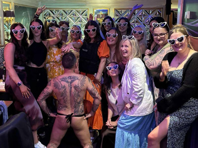 A topless man with a group of hens at Butler in the Buff 