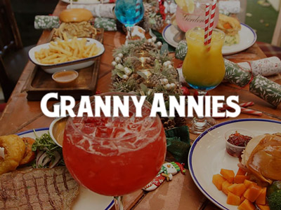A variety of food and cocktails on a table at Granny Annies