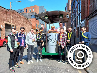 A group of men on a beer bike drinking beer