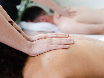 Someone at Glo Pamper massaging someones back