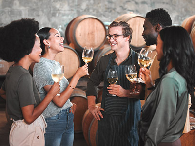 A group of people smelling and tasting wines
