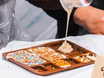 Someone pouring out chocolate into a mould