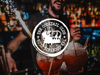 Two cocktails with sparklers on a bar at the Cocktail Club