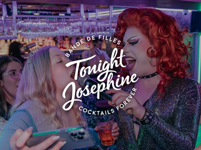 A drag queen holding a microphone to someone at Tonight Josephine