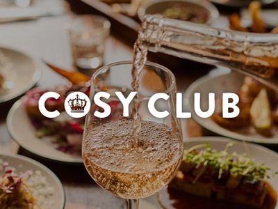 Someone pouring a glass of wine at Cosy Club