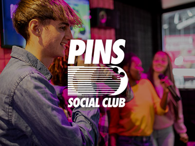 People singing karaoke at Pins in Liverpool